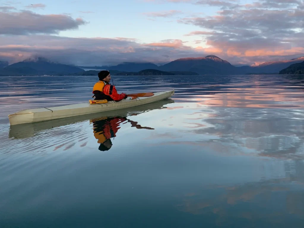 Lou Logan paddling a skin-on-frame kayak near Juneau